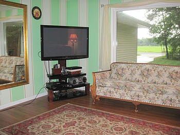 Living room with laminate floors and large sunny picture window 