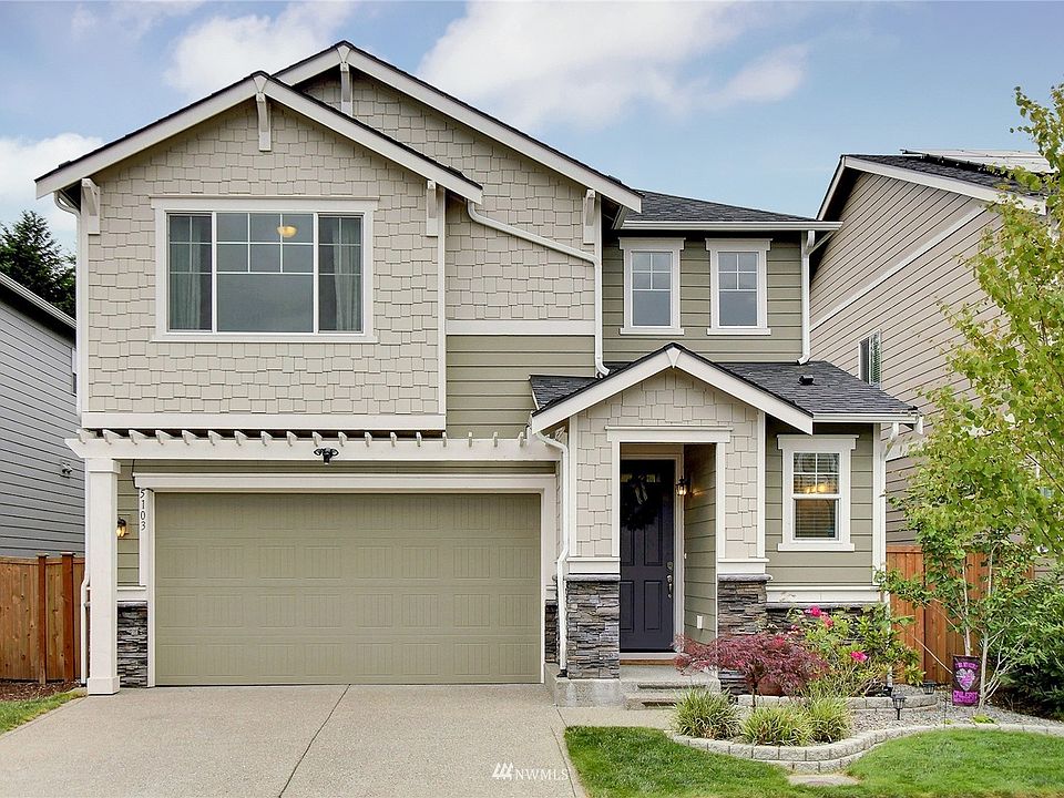 Front view of home, and you will notice the garage door is higher than others in the neighborhood enabling larger vehicle parking. >
