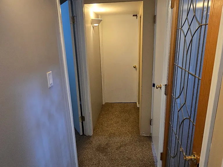 Lower level hallway leading to w/d, bathroom , garage