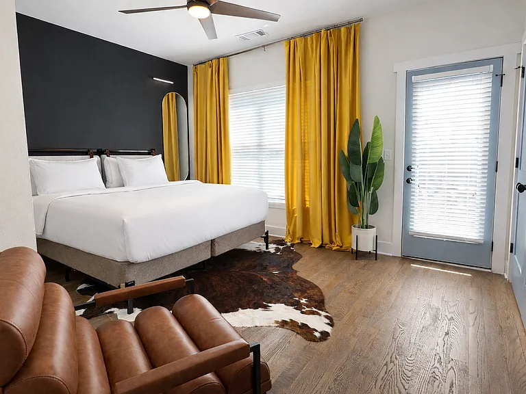 Located on the 2nd floor, the Beltline Suite features plush bedding and luxe linens, bedside charging, blackout curtains, dresser, a ceiling fan, Smart TV, bathroom and deck, all wrapped in thoughtfully curated designer interiors for a stylish stay.