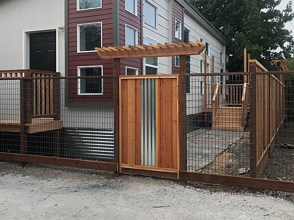 Entry/parking under construction. Landscaping and vines on the fence coming!