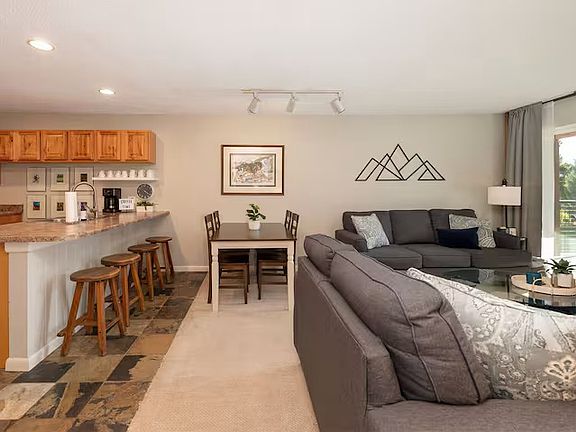 Living Room and Dining Area-seats 8 with four at the bar and four at the table.