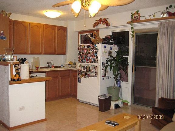 Tile floor in the kitchen with dishwasher and a nice deck outside.