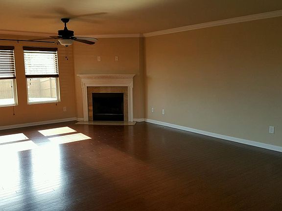 Spacious living room with hardwood flooring and a wood burni