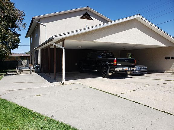 2 Parking spots (1 under carport, 1 Next to carport) outside storage under carport.