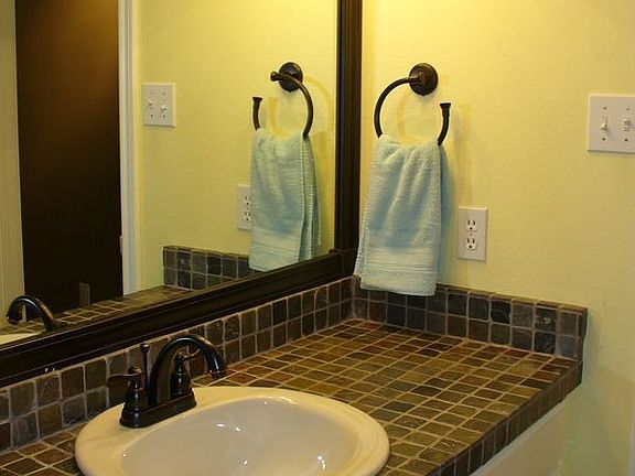 Ceramic tile flooring, slate tile counter, new sink, faucet, & light fixture