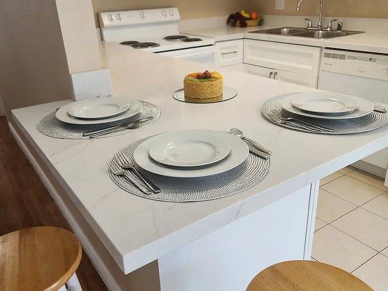 Brand new elegant quartz countertops and breakfast bar, seats up to 3 people