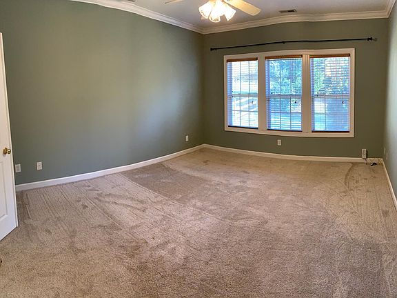 Large master bedroom overlooking private backyard.