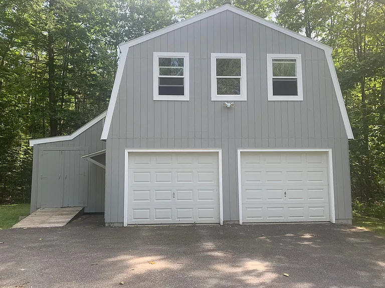 Oversize garage with unfinished bonus room. 1 of the two bays included in rent. Large storage area to left.