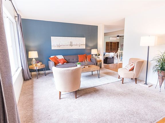 The living room area as you come in through the front door. Hardwood floors at the entry way.