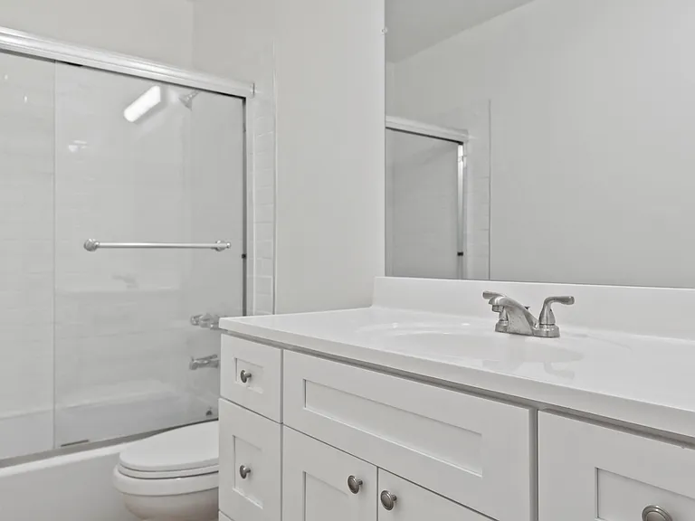 Bathroom with Shower Bath with Glass Door and Vanity Cabinet Storage