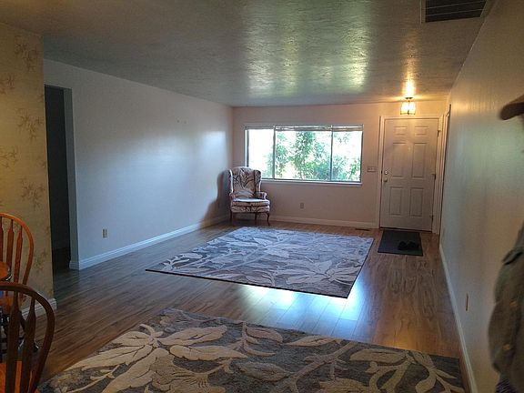 front living room, Dining area in foreground is mostly not shown. Unfurnished, a table and chairs optional.