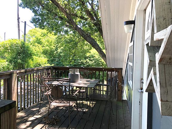 Peaceful outdoor private deck, surrounded by lush trees