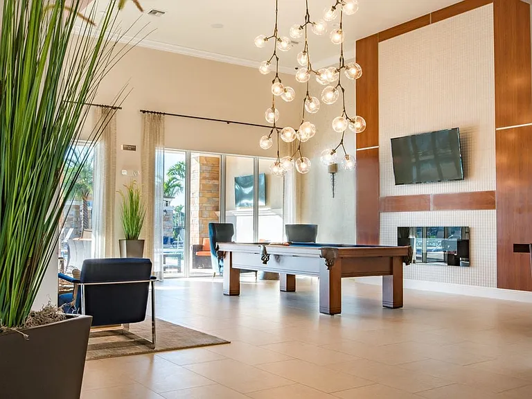 Resident lounge with TV, billiards, and fireplace