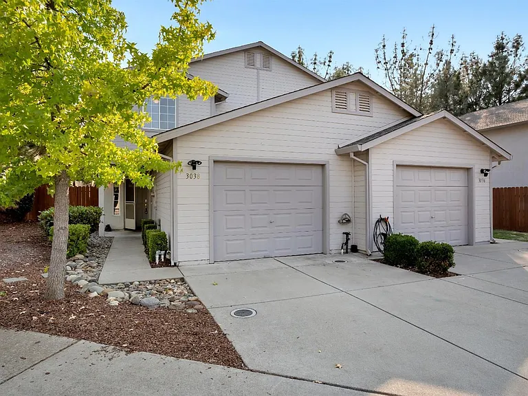 A view of the front of the home & driveway during midday.