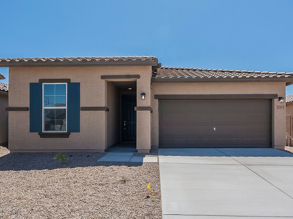 Elegant tile roofing and stylish blue shutters enhance this Rancho El Dorado home s facade.