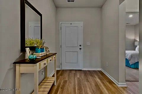 Entry Hall with front bedroom, hall bath and third bedroom to right.
