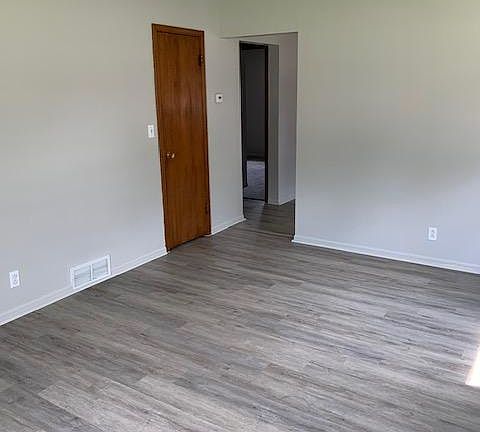 This photo shows the coat closet and entrance to the kitchen