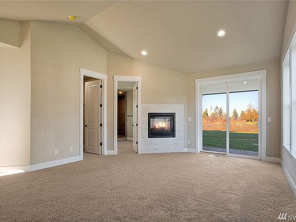 Main floor master suite is wonderfully spacious room with high vaulted ceilings and adjoining walk-in closet and ensuite. 