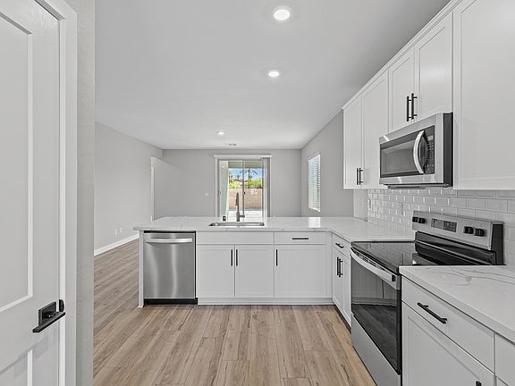 The living area is filled with natural lighting from beautiful sliding glass doors.