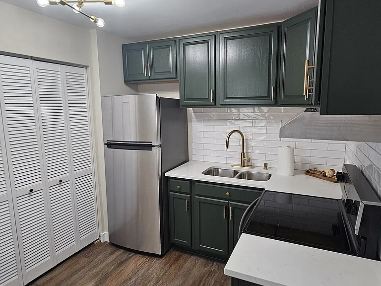 Newly renovated kitchen with new backsplash, flooring, appliances, fixtures and cabinets
