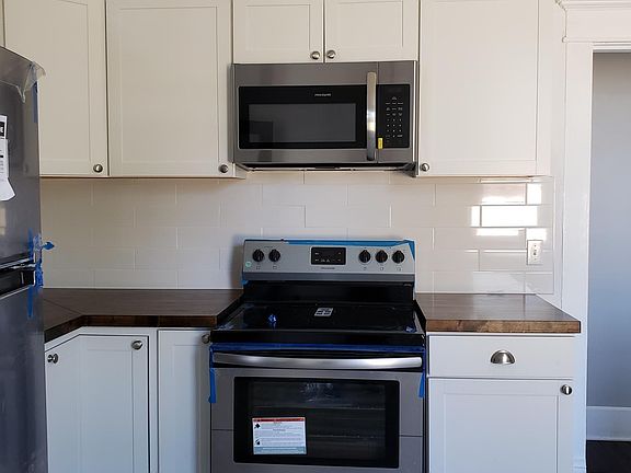 Brand new designer kitchen with stainless, tile backsplash,