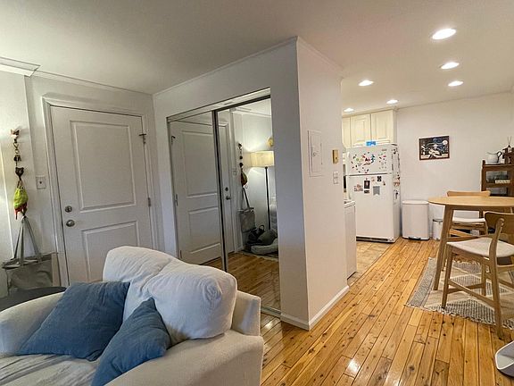 Front entry, coat closet, and dining area as seen from living room.