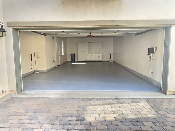 Cavernous 4-car garage with epoxyed floor and workspace in the rear.