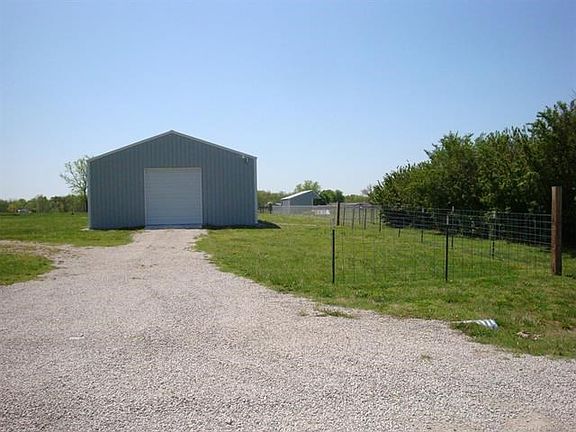 Recently built shop/storage building. Approx 30' x 50'. Garage doors on both ends & man door on W side.