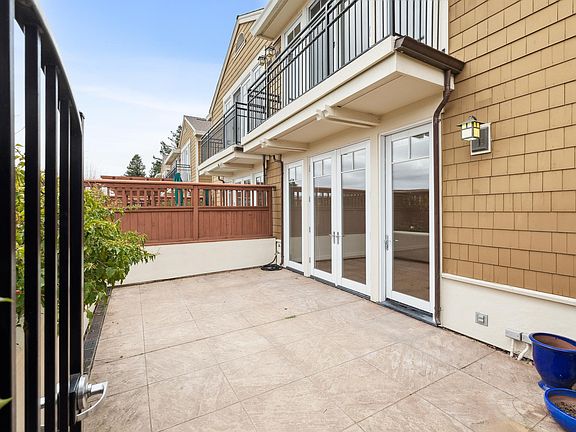 The spacious front patio with French doors leading to the main living level.