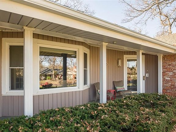 Pretty covered front porch is a great spot to hang out and watch the neighbors go by. The paint colo