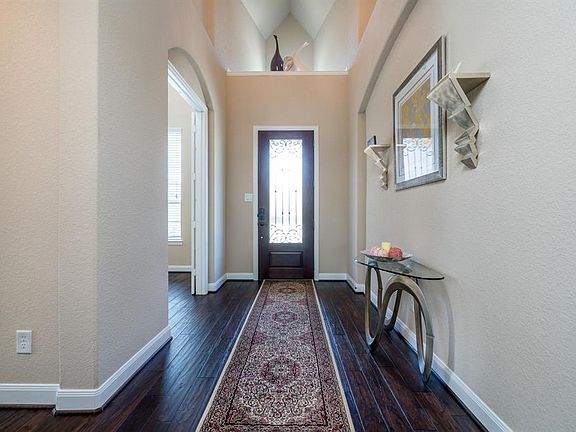 Handsome 8' wood door at the entry with scroll details and niche above.