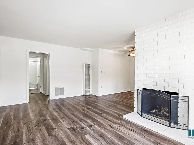 Open-Concept Living Room with a Fireplace and Vinyl Flooring