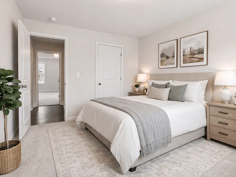 Secondary bedroom with queen size bed and large window letting in a ton of natural light.