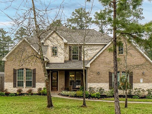 Lovely recent construction located on almost an acre in Magnolia Ranch Estates. Stone and brick exterior plus a side entry garage makes for a beautiful facade.