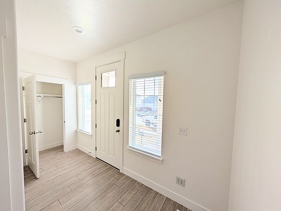Welcoming entryway with a convenient coat closet for easy storage of jackets, shoes, and everyday essentials.