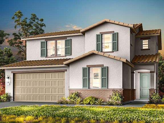 A two-story Mediterranean-style house with a garage, surrounded by lush greenery and a well-manicure