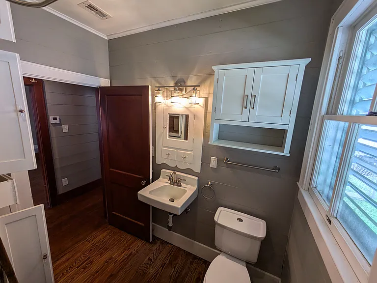Bath has original wall mount medicine cabinet and shiplap walls updated with new plumbing & electrical.