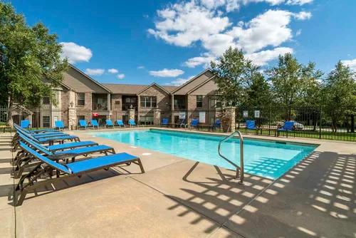 On a hot day, you'll love taking a dip in the pool and relaxing in the lounge chairs. - Stone Creek Villas