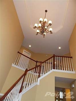 This view shows the beautiful tray ceiling in the foyer.