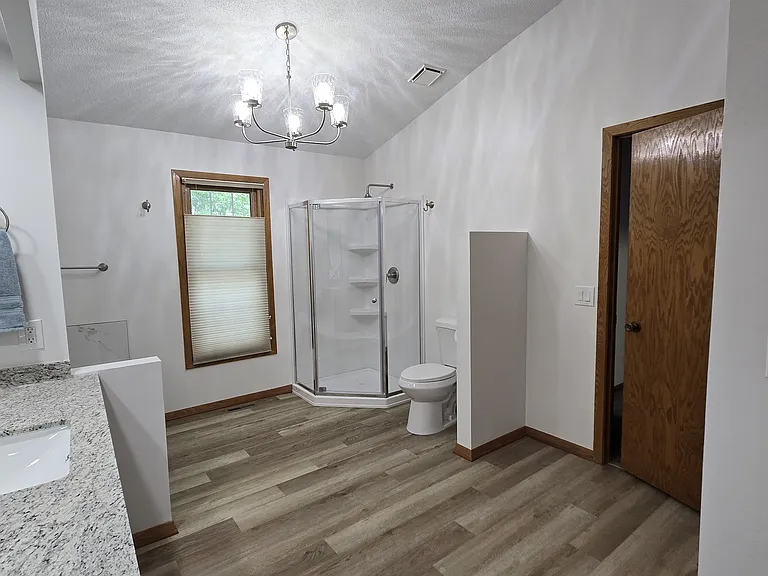 Master bath with granite counters, shower and tub.