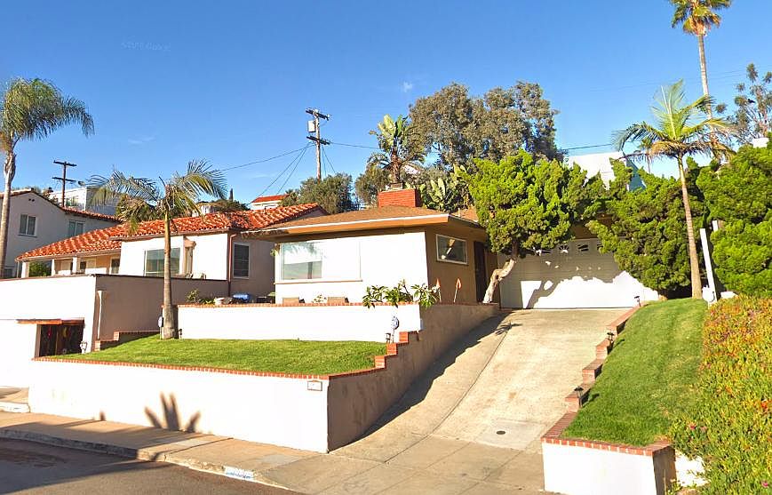 Front of home has large ocean view patio and natural grass lawns.