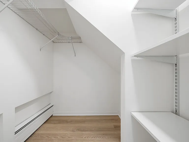 Walk in closet with clothes rack, shelves and storage space
