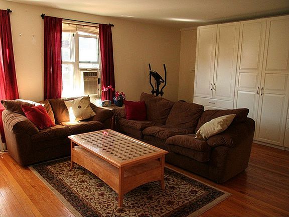Living room. Large insulated windows. Wall of storage units.