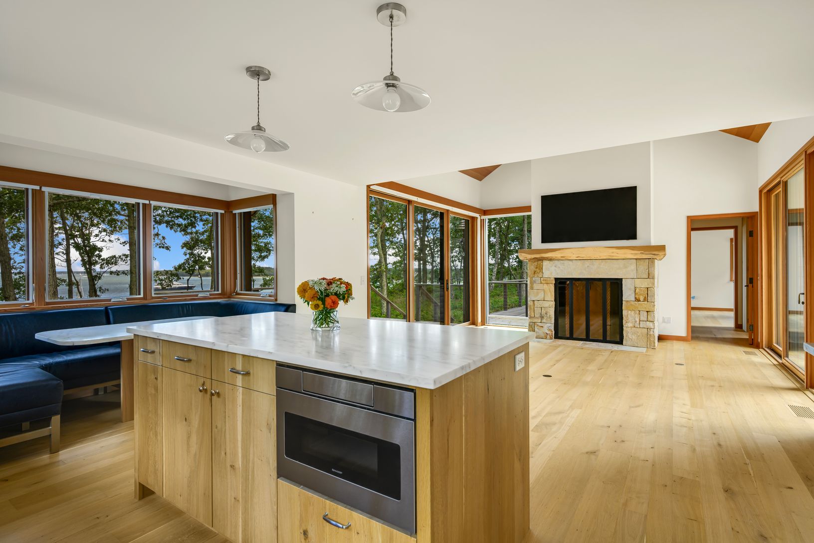  Kitchen island looking toward built in banquet seating and living room beyond