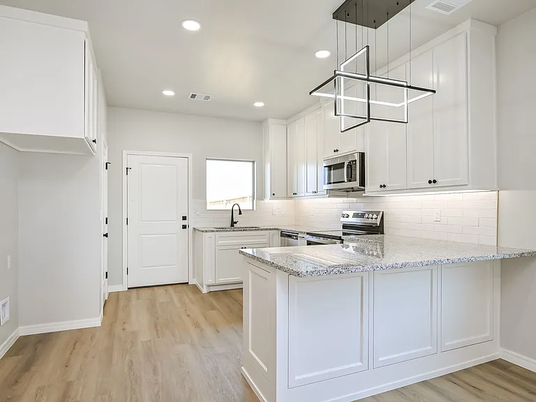 Granite countertops. Stainless steel microwave, dishwasher, and stove included.