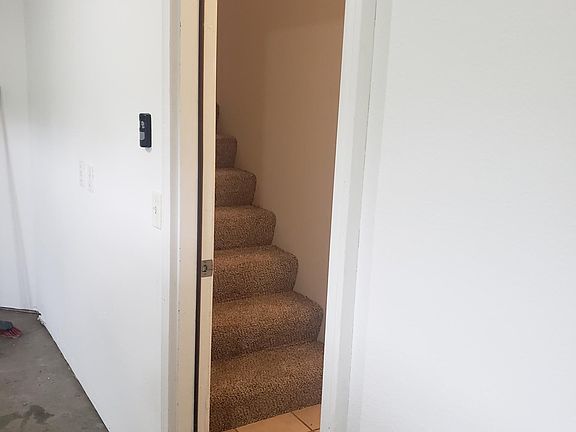 Stairs leading to front door view from garage