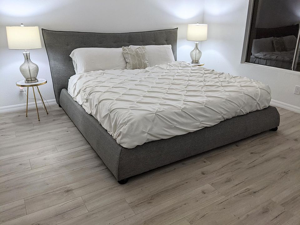 Master Bedroom Furnished with Cal King Bed. Private attached bathroom renovated with real white carrara marble countertops and mosaic tile shower