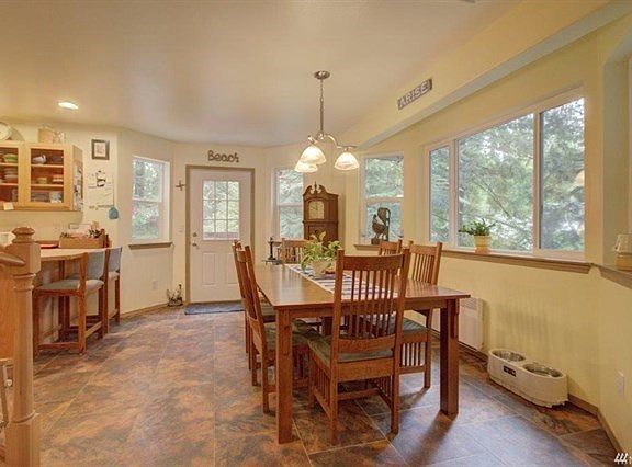 Dinning room.  The window area and the back door area kick-out a little.  Kitchen is to the left.  The flooring is Veristone marble composite tile.  It is also throughout the kitchen area.