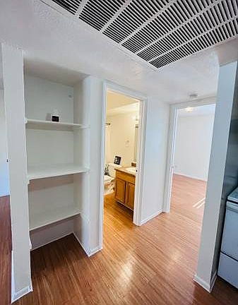 Here would be a small hallway that divides the kitchen from the bathroom and also some extra shelves.